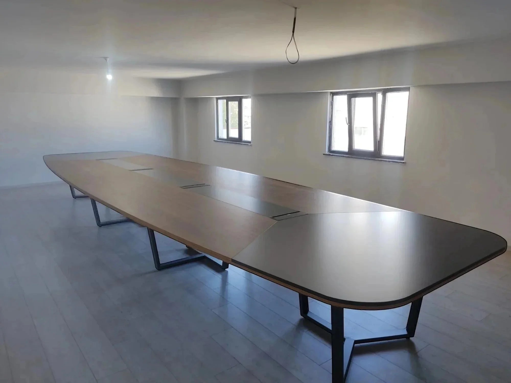 İstanbul Ofis Mobilya modern ahşap ve gri detaylı, kablo yönetimli 20-22 kişilik büyük oval toplantı masası.